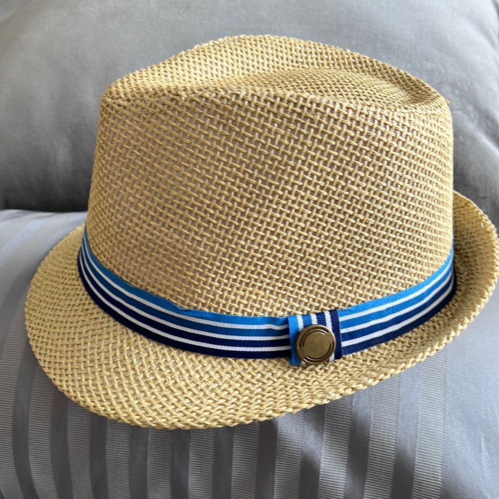 Light tan colored wicker Fedora w/blue striped rim and bronze colored accent.
